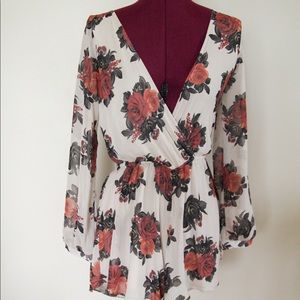 Floral long sleeve romper. A small mark or two that are not noticeable